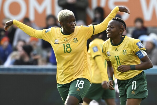 South Africa's Thembi Kgatlana, right, celebrates with teammate Sibulele Holweni after scoring her team's second goal during the Women's World Cup Group G soccer match between Argentina and South Africa in Dunedin, New Zealand, Friday, July 28, 2023. (AP Photo/Andrew Cornaga)