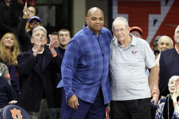 Former Auburn and NBA player, Charles Barkley, left, hugs former Auburn coach Sonny Smith as he is honored before the first half of an NCAA college basketball game between Auburn and Oklahoma Saturday, Jan. 29, 2022, in Auburn, Ala. (AP Photo/Butch Dill)