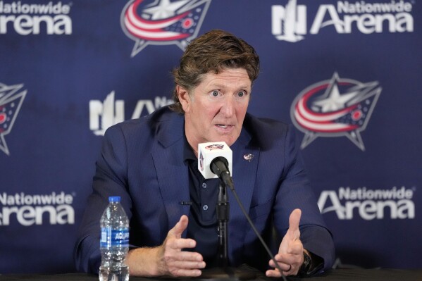 FILE - New Columbus Blue Jackets NHL hockey head coach Mike Babcock speaks to the media during an introductory press conference Saturday, July 1, 2023, in Columbus, Ohio. Babcock and Boone Jenner blasted comments made on a hockey podcast about the new Columbus Blue Jackets coach asking the captain to show him photos on his phone. (Kyle Robertson/The Columbus Dispatch via AP, File)