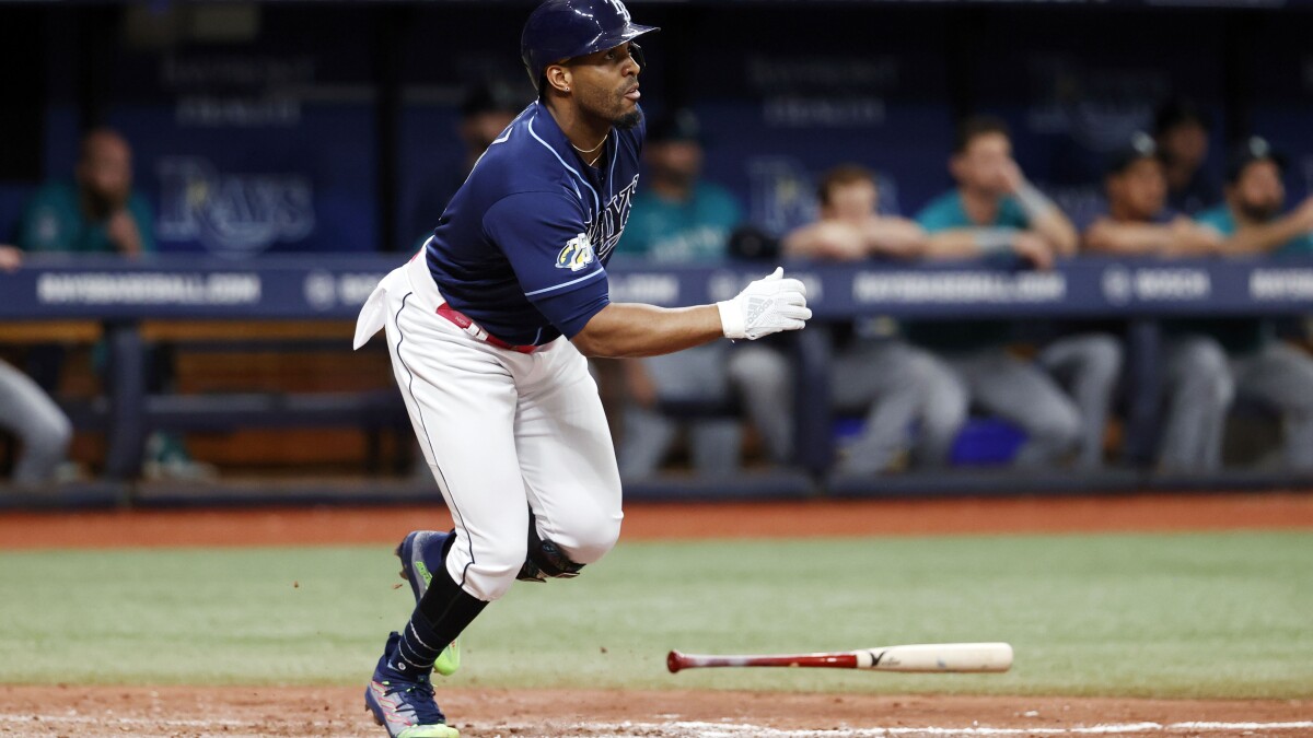 Seattle Mariners center fielder Julio Rodriguez is unable to make a catch  on a solo home run ball hit by Los Angeles Dodgers' James Outman during the  eighth inning of a baseball