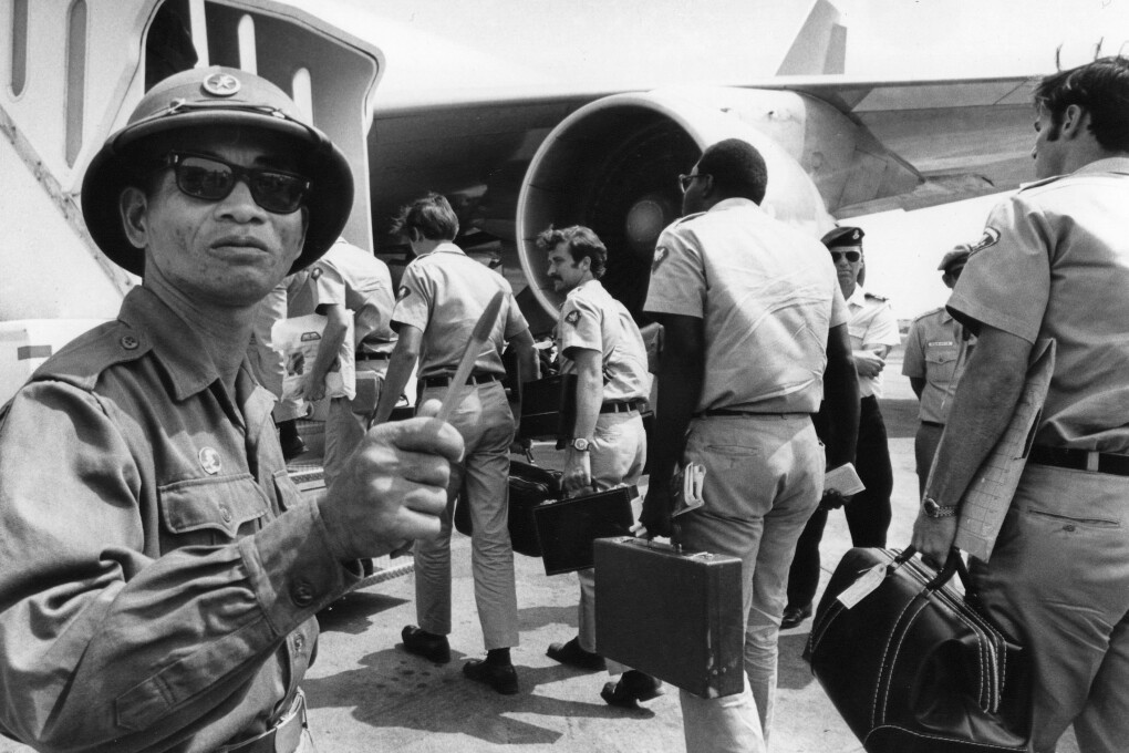 A Viet Cong observer of the Four Party Joint Military Commission counts U.S. troops as they prepare to board jet aircraft at Saigonís Tan Son Nhut airport, March 28, 1973.  Nineteen planeloads of U.S. personnel left Vietnam as the withdrawal of American troops drew to a close according to the provisions of the Paris Accords. (AP Photo/Neal Ulevich)