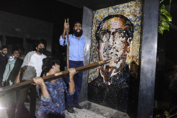 Protesters vandalize a portrait of Sheikh Mujibur Rahman, Bangladesh's former leader and the father of the country's ousted Prime Minister Sheikh Hasina, at his residence at Dhanmondi, in Dhaka in Dhaka, Bangladesh, Wednesday, Feb. 5, 2025. (AP Photo/Mahmud Hossain Opu)