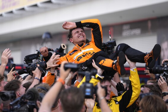 McLaren driver Lando Norris, of Britain, is lifted after winning the Miami Formula One Grand Prix auto race Sunday, May 5, 2024, in Miami Gardens, Fla. (AP Photo/Rebecca Blackwell)