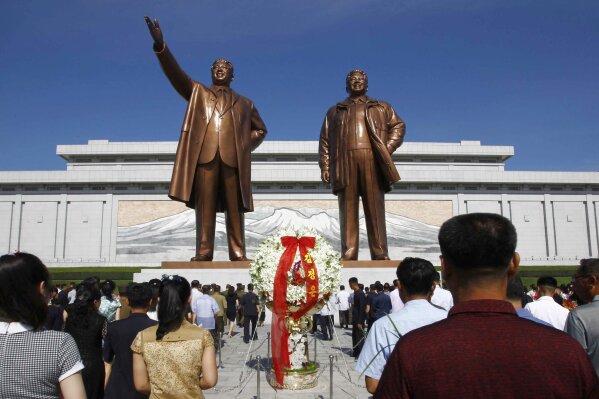 FILE - In this July 8, 2019, file photo, people visit Mansu Hill to pay tribute to the late leaders Kim Il Sung and Kim Jong Il on the occasion of the 25th anniversary of Kim Il Sung's death, in Pyongyang, North Korea. A panel monitoring U.N. sanctions said Monday, Aug. 5, that North Korean cyber experts have illegally raised money for the country's weapons of mass destruction programs "with total proceeds to date estimated at up to $2 billion." (AP Photo/Jon Chol Jin, File)