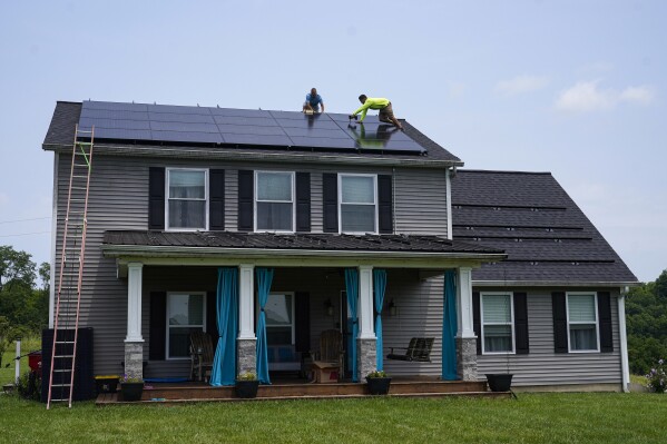 FILE - Solar panels are installed on the roof of a home in Frankfort, Ky., Monday, July 17, 2023. Residential solar is gaining traction in the U.S., with about 4.5 million homes now with solar rooftops. The share of electric vehicles in the U.S. is also growing. Many people with EVs become interested in charging them on solar energy, if they own their own roofs. (AP Photo/Michael Conroy, File)