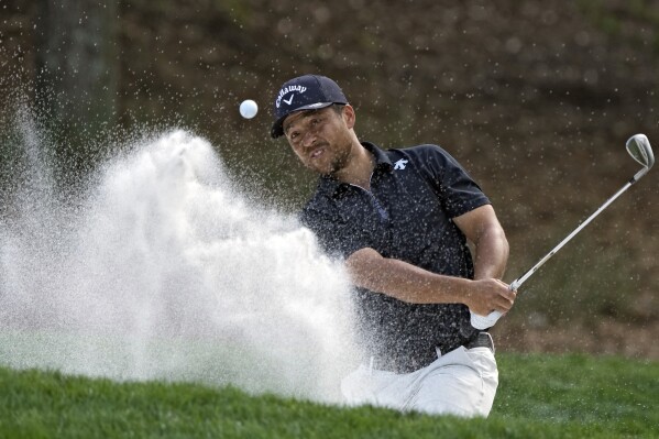 Xander Schauffele blasts from the sand on the eighth hole during the third round of The Players Championship golf tournament Saturday, March 16, 2024, in Ponte Vedra Beach, Fla. (AP Photo/Lynne Sladky)