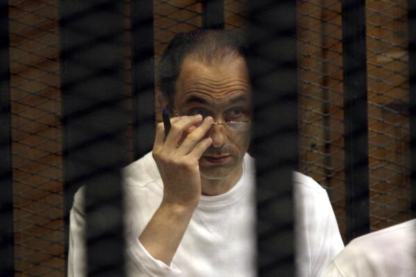 FILE - Gamal Mubarak sits behind bars at the second session of his trial on charges of insider trading in Cairo Criminal Court in Cairo, Egypt, on Sept. 8, 2012. Mubarak, the son of Egypt's former president said Tuesday, May 17, 2022, that he and family members were innocent of corruption charges made in international courts after the country’s 2011 popular uprising. His statements came after years of attempts by the deposed president's family to rehabilitate its image as it faced litigation in Egypt and abroad.   (AP Photo/Ahmed Gomaa, File)