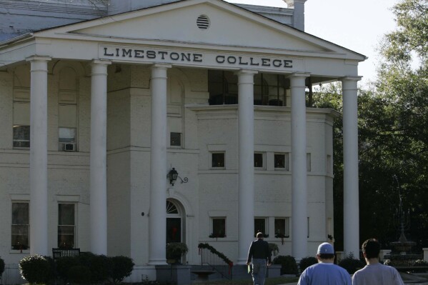 Limestone College students walk across campus Monday, Dec. 11, 2006, in Gaffney, S.C.. The school announced late Tuesday it will close after failing to raise $6 million. (AP Photo/Mary Ann Chastain, File)