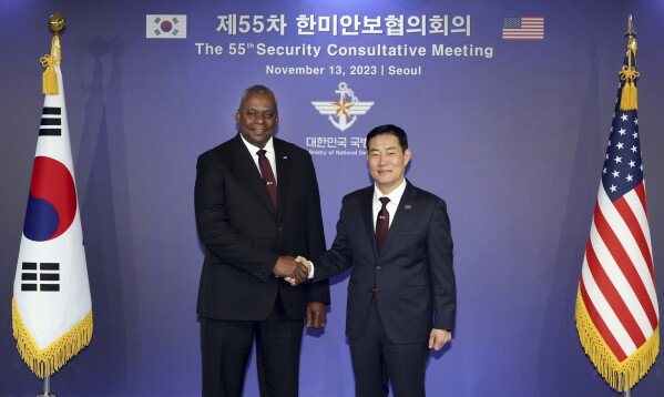 In this photo provided by the South Korea Defense Ministry, U.S. Secretary of Defense Lloyd Austin, left, and his South Korean counterpart Shin Won-sik shake hands for a photo ahead of the 55th Security Consultative Meeting (SCM) at the defense ministry in Seoul, South Korea, Monday, Nov. 13, 2023. (South Korea Defense Ministry via AP)