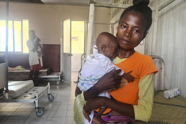 Mother Iavosoa, who only gave her first name, and her 10-month-old daughter Soaravo, who is suffering with acute malnutrition, at a hospital in Mananjary, Madagascar, Wednesday, March 8, 2023. Southeastern Madagascar has been battered by three intense cyclones in the space of a year and humanitarian groups say it is now facing a hunger emergency because of those climatic disasters. (AP Photo/Sarah Tetaud)