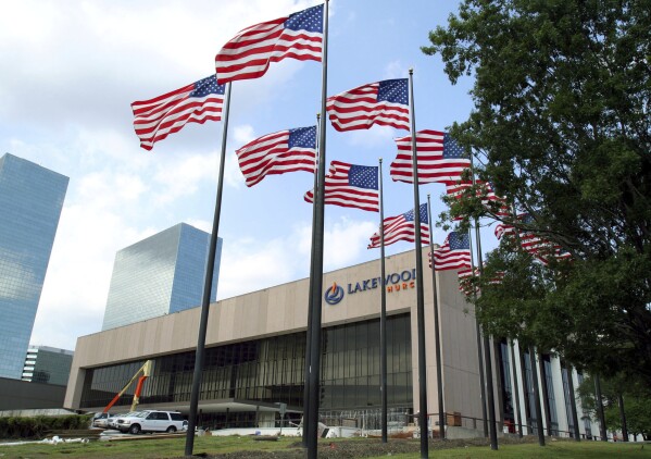 FILE - Flags fly in front of the Lakewood Church in Houston, June 28, 2005. Police in Texas said Sunday, Feb. 11, 2024, that they were responding to a possible shooting at the Houston megachurch run by celebrity pastor Joel Osteen. (AP Photo/Pat Sullivan, File)