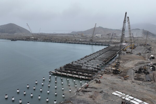 Cranes work in the construction of the Chancay Multipurpose Port Terminal, built by a Chinese company in Chancay, Peru, Tuesday, Aug. 22, 2023. (AP Photo/Cesar Barreto)