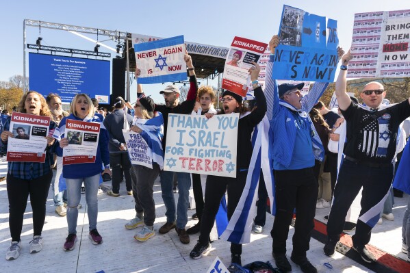 Participants hold signs as they stand on the National Mall at the March for Israel on Tuesday, Nov. 14, 2023, in Washington. (AP Photo/Manuel Balce Ceneta)