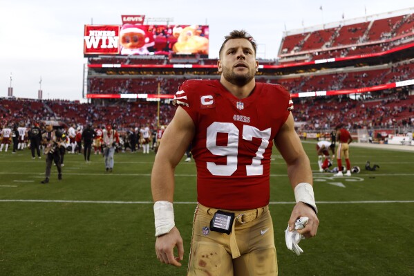 FILE -San Francisco 49ers defensive end Nick Bosa walks off the field after an NFL football game against the Washington Commanders, Saturday, Dec. 24, 2022, in Santa Clara, Calif. Nick Bosa's lengthy contract holdout ended four days before the start of the season for the San Francisco 49ers when he agreed to a contract extension that will make him the NFL's richest defensive player ever. Coach Kyle Shanahan said Wednesday, Sept. 6, 2023 that the two sides agreed to the contract and that Bosa is on his way to the team facility. (AP Photo/Jed Jacobsohn, File)