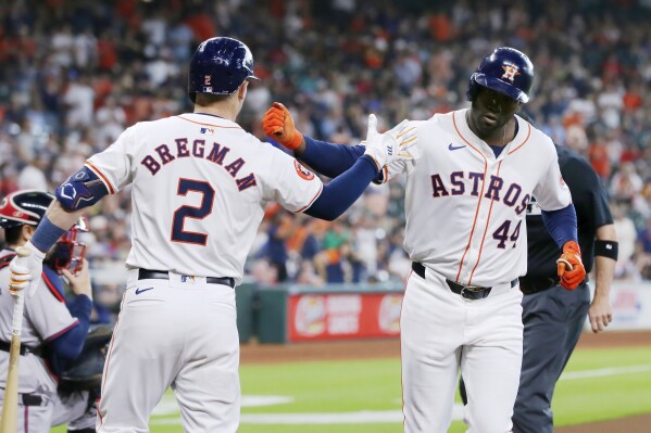 Houston Astros' Alex Bregman (2) and Yordan Alvarez (44) celebrate a home run by Alvarez during the first inning of a baseball game against the Atlanta Braves, Wednesday, April 17, 2024, in Houston. (AP Photo/Michael Wyke)