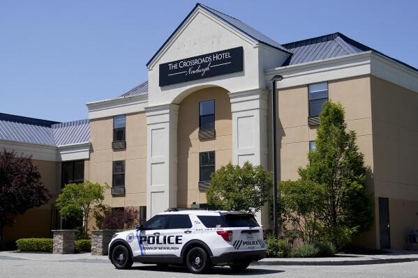 FILE - A Town of Newburgh police vehicle sits parked outside The Crossroads Hotel, where two busloads of migrants arrived hours earlier, on May 11, 2023, in Newburgh, N.Y. The founder of a nonprofit group has been accused of fabricating a story about homeless military veterans being evicted from the hotel to make room for international migrants, a tale that stoked days of outrage on cable news networks. (AP Photo/John Minchillo, File)