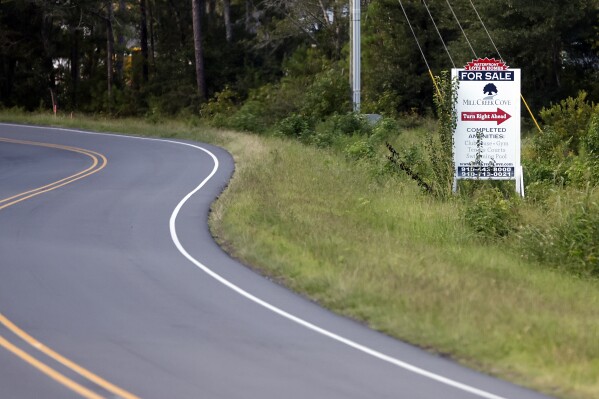 A for sale sign is advertised near wetlands in Oak Island, N.C., Tuesday, Aug. 29, 2023. The Biden Administration weakened protections for wetlands on Tuesday, a win for developers and agricultural groups in some states. (AP Photo/Karl B DeBlaker)