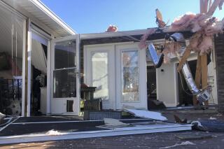 Damage scatters the rear of Tim Long's home in Ocean Isle Beach, N.C., Feb. 16, 2021, following a tornado that struck the area the previous night. The twister that hit Ocean Isle Beach in February killed three people and injured about 10 others. (AP Photo/Bryan Anderson)