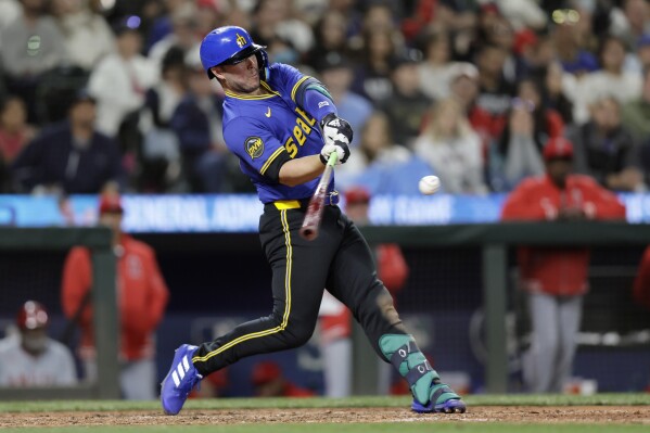 Seattle Mariners' Ty France hits a solo home run off Los Angeles Angels pitcher Matt Moore during the eighth inning of a baseball game Friday, May 31, 2024, in Seattle. (AP Photo/John Froschauer)