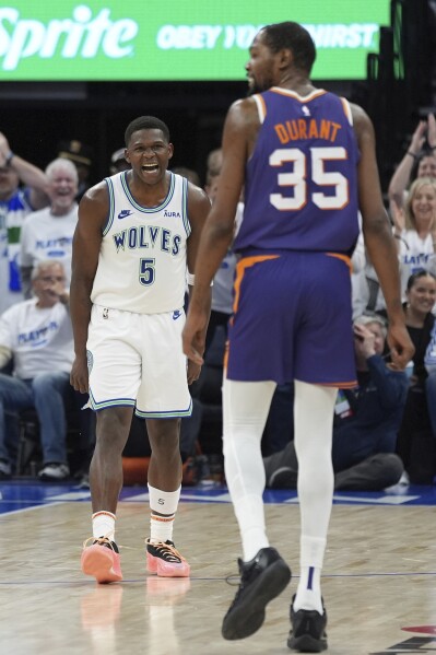 Minnesota Timberwolves guard Anthony Edwards (5) celebrates after making a 3-point shot during the second half of Game 1 of an NBA basketball first-round playoff series agains the Phoenix Suns, Saturday, April 20, 2024, in Minneapolis. (AP Photo/Abbie Parr)