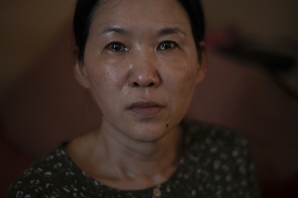 Yooree Kim, who was 11 when she was sent by an adoption agency to a couple in France, sits for a portrait as tears well up in her eyes in her apartment in Seoul, South Korea, Sunday, May 19, 2024. (AP Photo/Jae C. Hong, File)