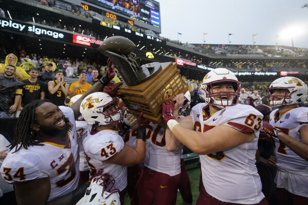 FILE - Iowa State players celebrate with the Cy-Hawk Trophy after an NCAA college football game against Iowa, Sept. 10, 2022, in Iowa City, Iowa. The CyHawk Game ratchets up the intensity of the Iowa and Iowa State fan bases every year, and that will be no different on Saturday, Sept. 9, 2023, when the teams meet in Ames. (AP Photo/Charlie Neibergall, File)