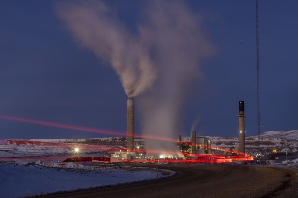 FILE - Taillights trace the path of a motor vehicle at the Naughton Power Plant, Jan. 13, 2022, in Kemmerer, Wyo. Bill Gates and his energy company are starting construction at their Wyoming site adjacent to the coal plant for a next-generation nuclear power plant he believes will “revolutionize” how power is generated. (AP Photo/Natalie Behring, File)