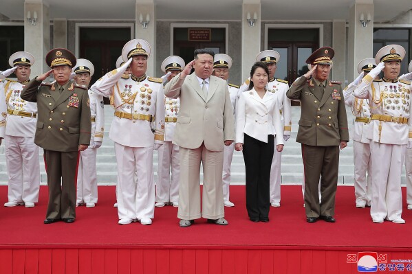 This photo provided on Tuesday, Aug. 29, 2023, by the North Korean government, North Korean leader Kim Jong Un, center, with his daughter, center right, reportedly named Ju Ae, review the honor guard during their visit to the navy headquarter in North Korea, on Aug. 27, 2023. Independent journalists were not given access to cover the event depicted in this image distributed by the North Korean government. The content of this image is as provided and cannot be independently verified. Korean language watermark on image as provided by source reads: 