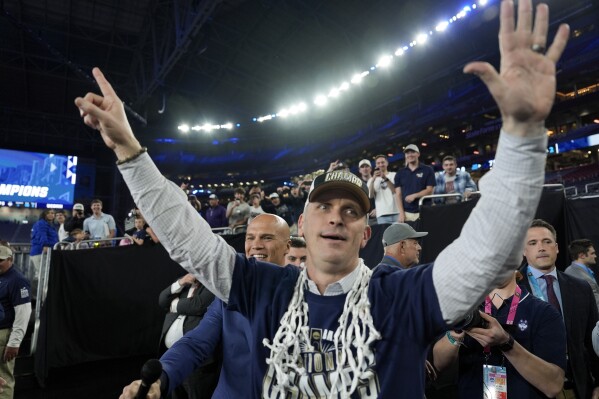 UConn head coach Dan Hurley greets fans after their win against Purdue in the NCAA college Final Four championship basketball game, Monday, April 8, 2024, in Glendale, Ariz. (AP Photo/David J. Phillip)