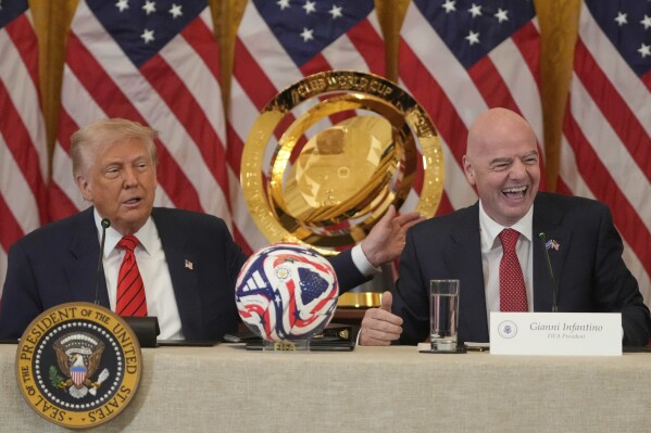President Donald Trump and FIFA President Gianni Infantino talk during a FIFA task force meeting in the East Room of the White House, Tuesday, May 6, 2025, in Washington. (AP Photo/Mark Schiefelbein)