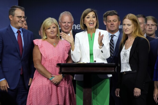 FILE - Iowa Gov. Kim Reynolds reacts after signing a new law banning abortions after six weeks of pregnancy before speaking at the Family Leadership Summit, Friday, July 14, 2023, in Des Moines, Iowa. (AP Photo/Charlie Neibergall, File)