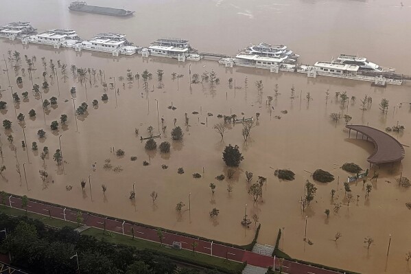 In this picture taken through a window a flooded riverside park is seen along the Beijiang River in Qingyuan city in southern China's Guangdong province Monday, April 22, 2024. Heavy rainstorms that swept across southern China over the weekend have killed some in riverside cities while tens of thousands have been evacuated across Guangdong and in emergency shelters. (Chinatopix Via AP)