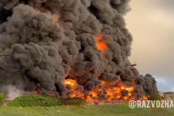In this handout photo taken from video released by the Governor of Sevastopol Mikhail Razvozhaev telegram channel on Saturday, April 29, 2023, smoke and flame rise from a burning fuel tank in Sevastopol, Crimea. A massive fire erupted at an oil reservoir there after it was hit by a drone, a Russian-appointed official there reported on Saturday. (Sevastopol Governor Mikhail Razvozhaev telegram channel via AP)
