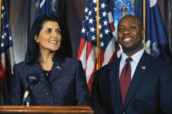 FILE - South Carolina Gov. Nikki Haley, left, announces Rep. Tim Scott, right, as Sen. Jim DeMint's replacement in the U.S. Senate during a news conference at the South Carolina Statehouse, Dec. 17, 2012, in Columbia, S.C. Haley and Scott are forever linked by that announcement, cementing their status as rising stars in a Republican Party frustrated by Barack Obama's reelection just a month earlier. But nearly a dozen years later, they find themselves poised to run against each other for the GOP presidential nomination. Haley has already launched a campaign, and Scott took steps last week toward initiating a bid of his own. (AP Photo/Rainier Ehrhardt, File)