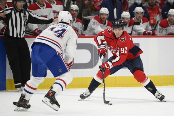 Washington Capitals center Evgeny Kuznetsov (92) skates with the puck against Montreal Canadiens center Nick Suzuki (14) during the first period of an NHL hockey game Wednesday, Nov. 24, 2021, in Washington. (AP Photo/Nick Wass)