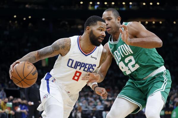 Los Angeles Clippers forward Marcus Morris Sr. (8) drives against Boston Celtics center Al Horford (42) during the first half of an NBA basketball game Wednesday, Dec. 29, 2021, in Boston. (AP Photo/Mary Schwalm)
