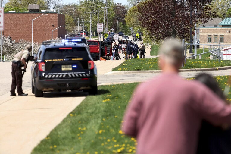 Law enforcement personnel respond to a report of a person armed with a rifle at Mount Horeb Middle School in Mount Horeb, Wis., Wednesday, May 1, 2024. The school district said a person it described as an active shooter was outside a middle school in Mount Horeb on Wednesday but the threat was “neutralized” and no one inside the building was injured. (John Hart/Wisconsin State Journal via AP)