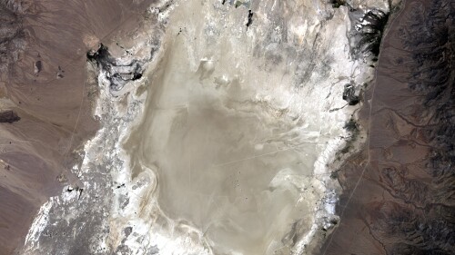 In this undated photo provided by NASA, a satellite captures the Railroad Valley (RRV), a dry lakebed in Nevada, for conducting ground-based calibration of Earth-observing satellite instruments. At the request of NASA, U.S. land managers have withdrawn about 36 square miles of federal land otherwise open to mineral exploration and mining at the site 250 miles northeast of Las Vegas. Nevada Republican Rep. Mark Amodei has introduced legislation that would rescind the land withdrawal and potentially reopen it to mining. (NASA via AP)