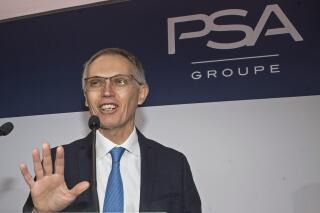 FILE - In this Feb. 26, 2020 file photo, CEO of PSA Groupe Carlos Tavares arrives for the presentation of the company's 2019 full year results in Rueil-Malmaison, west of Paris.  Stellantis is a little late to the global electric vehicle party, but on Thursday, July 8, 2021, it pledged to catch up and pass its competitors.  Tavares says that by 2025, 98 % of its models in Europe and North America will have electric versions.   (AP Photo/Michel Euler, File)