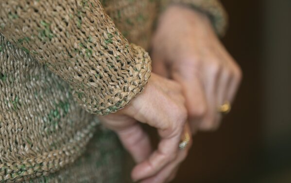 
              This March 19, 2019 photo shows detailed cuffs from a suit Rosa Ferrigno made from 300 plastic grocery bags in Greece, N.Y.  Ferrigno spent two months over the winter knitting a skirt and jacket from filmy brown bags scissored into thin strips tied together to make yarn. She says she did it just for fun.(Jamie Germano/Democrat & Chronicle via AP)/Democrat & Chronicle via AP)
            