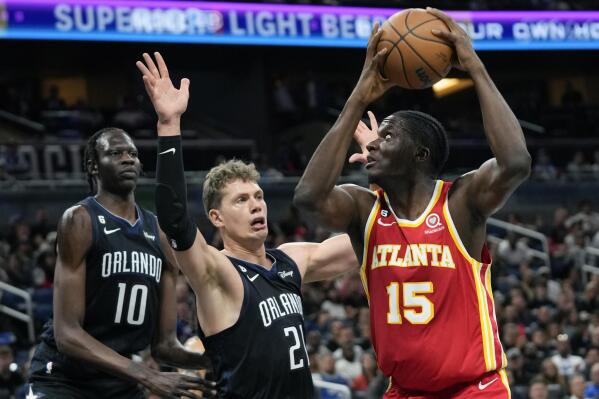 Atlanta Hawks' Clint Capela (15) looks for a shot against Orlando Magic's Moritz Wagner, center, and Bol Bol (10) during the first half of an NBA basketball game, Wednesday, Dec. 14, 2022, in Orlando, Fla. (AP Photo/John Raoux)