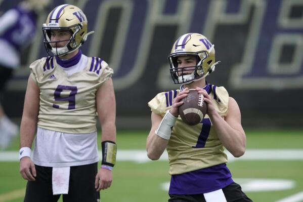FILE - Washington quarterback Sam Huard, right, drops to pass next to quarterback Dylan Morris, left, during the first day of NCAA college football practice in Seattle, in this Wednesday, April 7, 2021, file photo. The NCAA football oversight committee is preparing to recommend changes to preseason camp that will include fewer fully padded practices and the elimination of some old-school collision drills. The football oversight committee 's initial proposal called for at least nine of a team's 25 preseason practices to be run with players wearing helmets but no other pads, and no more than eight fully-padded, full-contact practices. (AP Photo/Ted S. Warren, File)