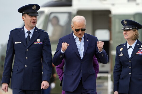 President Joe Biden walks with Capt. Eric Anderson, deputy director of flightline protocol for the 89th Airlift Wing, and Col. Angela Ochoa, commander of the 89th Airlift Wing, right, before leaving Andrews Air Force Base, Md., Friday, March 8, 2024, to travel to Philadelphia for a campaign event. (AP Photo/Manuel Balce Ceneta)