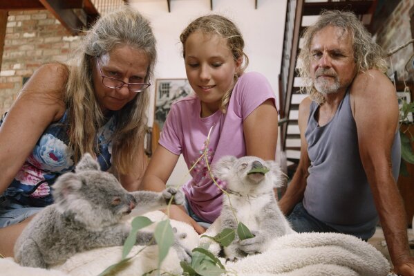 This image released by Netflix shows Ali Bee, from left, Izzy Bee and Tim Bee in a scene from "Izzy's Koala World," which follows an 11-year old girl as she helps her veterinarian mom take care of koalas. (Netflix via AP)