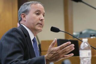 FILE - In this July 29, 2015, file photo, Texas Attorney General Ken Paxton speaks during a hearing in Austin, Texas. On the brink of bringing Paxton to trial on felony securities fraud charges, the government's prosecutors are threatening to bail out of the case unless they get paid. Paxton, a stockbroker and state lawmaker before being elected attorney general two years ago, was indicted for allegedly steering investors to a technology startup in 2011 without disclosing that he was being paid by the company. The trial is scheduled to start May 1, 2017. (AP Photo/Eric Gay, File)