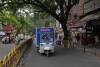 Balaji Premkumar, a 25-year-old rickshaw delivery driver, rides an electric vehicle which he switched to this year, in Bengaluru, India, Monday, May 29, 2023. At most traffic stops he's surrounded by gas-powered three-wheelers that rumble and rattle, spewing thick smoke into the air — something that his used to do, too, before he went electric. (AP Photo/Aijaz Rahi)