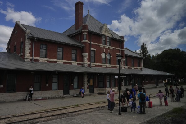 Passengers wait outside the train station Saturday, Aug. 10, 2024, in Dauphin, Manitoba. (AP Photo/Joshua A. Bickel)