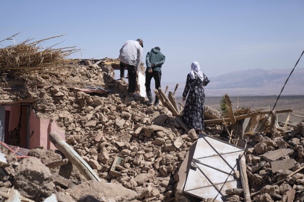 People inspect the damage caused by the earthquake in the village of Tafeghaghte, near Marrakech, Morocco, Monday, Sept. 11, 2023. (AP Photo/Mosa'ab Elshamy)