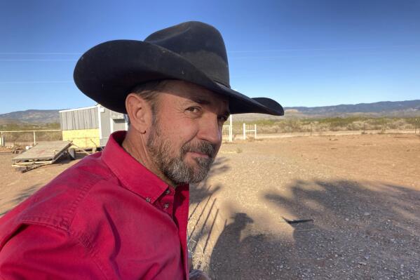 FILE - Otero County Commissioner Couy Griffin, the founder of Cowboys for Trump, takes in the view from his ranch in Tularosa, N.M., May 12, 2021. Griffin who helped found the group Cowboys for Trump is headed to trial in Washington next week on a charge related to the violent insurrection at the U.S. Capitol. And he plans to show up for court on horseback in a defiant show of support to the former president. (AP Photo/Morgan Lee, File)