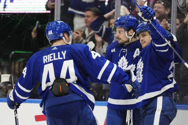 Toronto Maple Leafs' William Nylander (88) celebrates after his overtime goal against the Minnesota Wild with Auston Matthews (34) and Morgan Rielly (44) during NHL hockey game action in Toronto, Friday, Feb. 24, 2023. (Frank Gunn/The Canadian Press via AP)